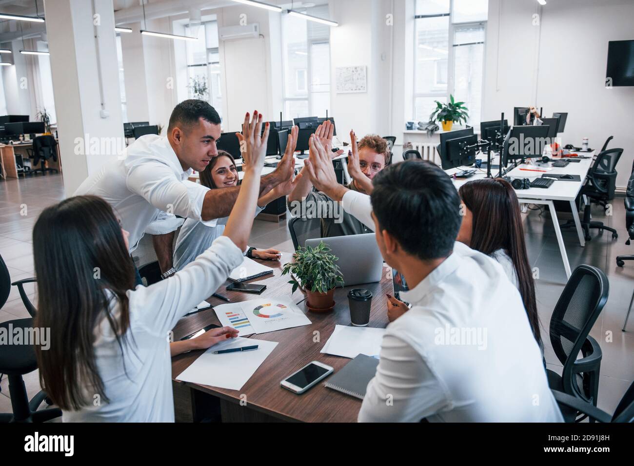 Young business people celebrating success in the modern office Stock ...