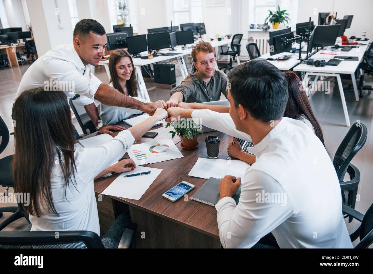 Young business people celebrating success in the modern office Stock ...
