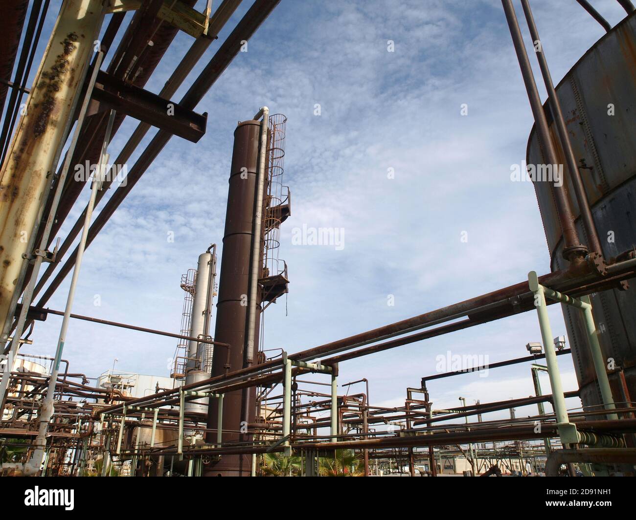 View of old rusty oil and petrochemical industrial refinery pipes. Stock Photo
