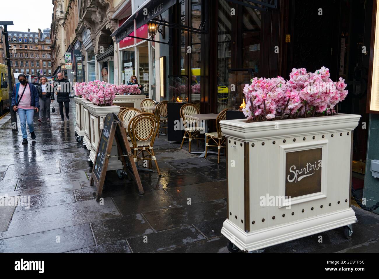 Glasgow,Scotland, UK. 2 November 2020. As Scotland enters new Coronavirus lockdown regulations the central belt and Glasgow are placed in Level 3 . Members of the public are seen out on the streets of central Glasgow for shopping and work. Pictured; Empty outdoor seating area decorated with flowers at Spuntini cafe.   Iain Masterton/Alamy Live News Stock Photo