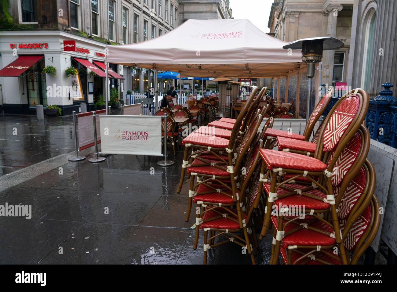 Glasgow,Scotland, UK. 2 November 2020. As Scotland enters new Coronavirus lockdown regulations the central belt and Glasgow are placed in Level 3 . Members of the public are seen out on the streets of central Glasgow for shopping and work. Pictured; Chairs stacked up at Di MaggioÕs restaurant with outdoor seating area empty.   Iain Masterton/Alamy Live News Stock Photo