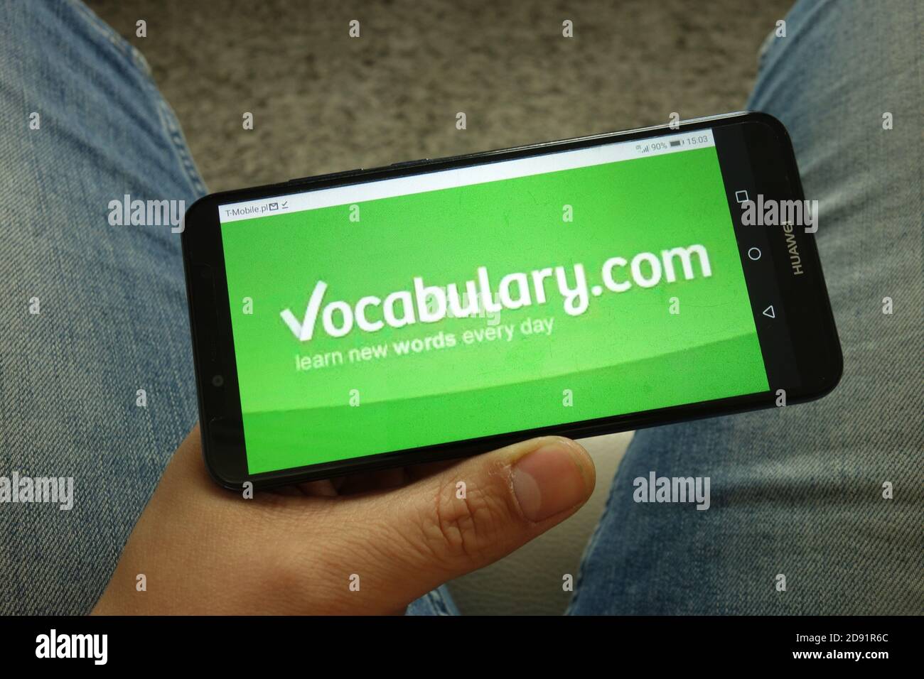 Man holding smartphone with website logo Stock Photo Alamy