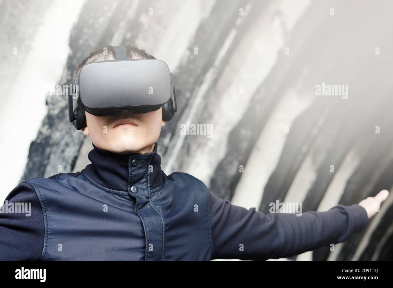 portrait of a young man enjoys virtual reality glasses during simulation training  with modern imaging future technologies Stock Photo