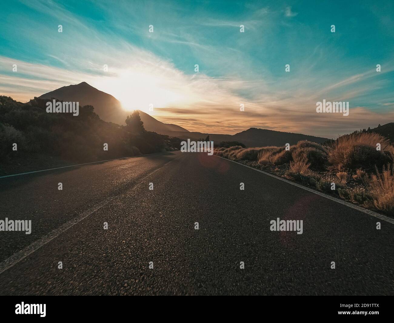 Long asphalt road ground view and travel concept - mountain and sky landscape - outdoor road trip in scenic place background Stock Photo