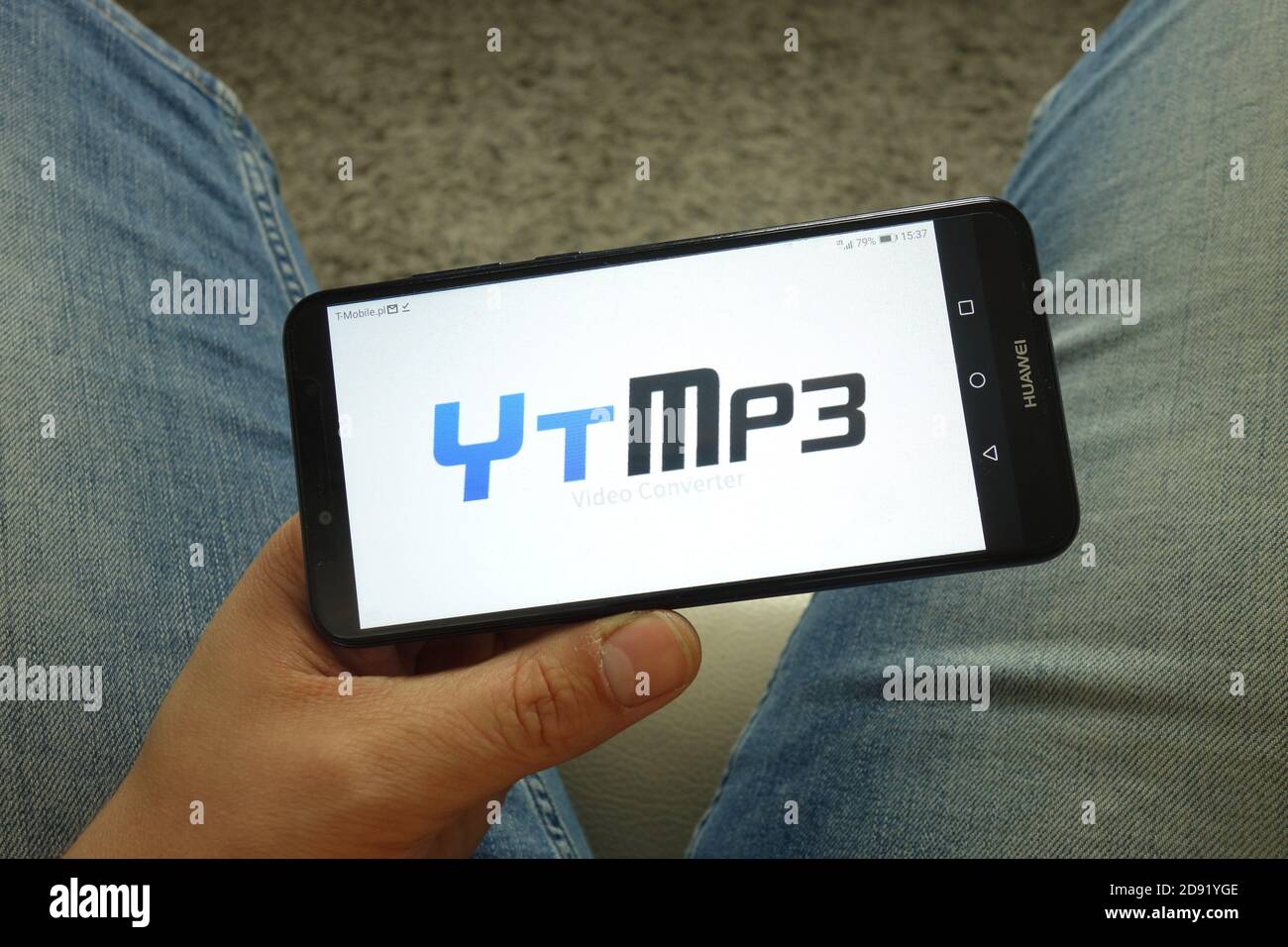 Man holding smartphone with Ytmp3 video converter logo Stock Photo - Alamy