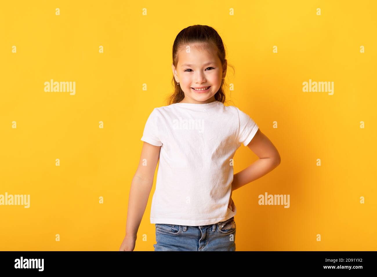 Smiling asian girl posing and looking at camera Stock Photo