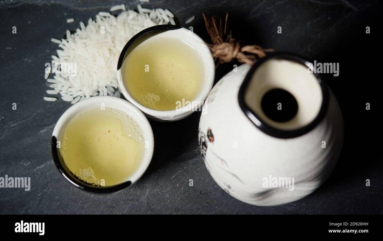 Pouring Sake Into Sake Cup, Traditional Japanese Drink Stock Photo
