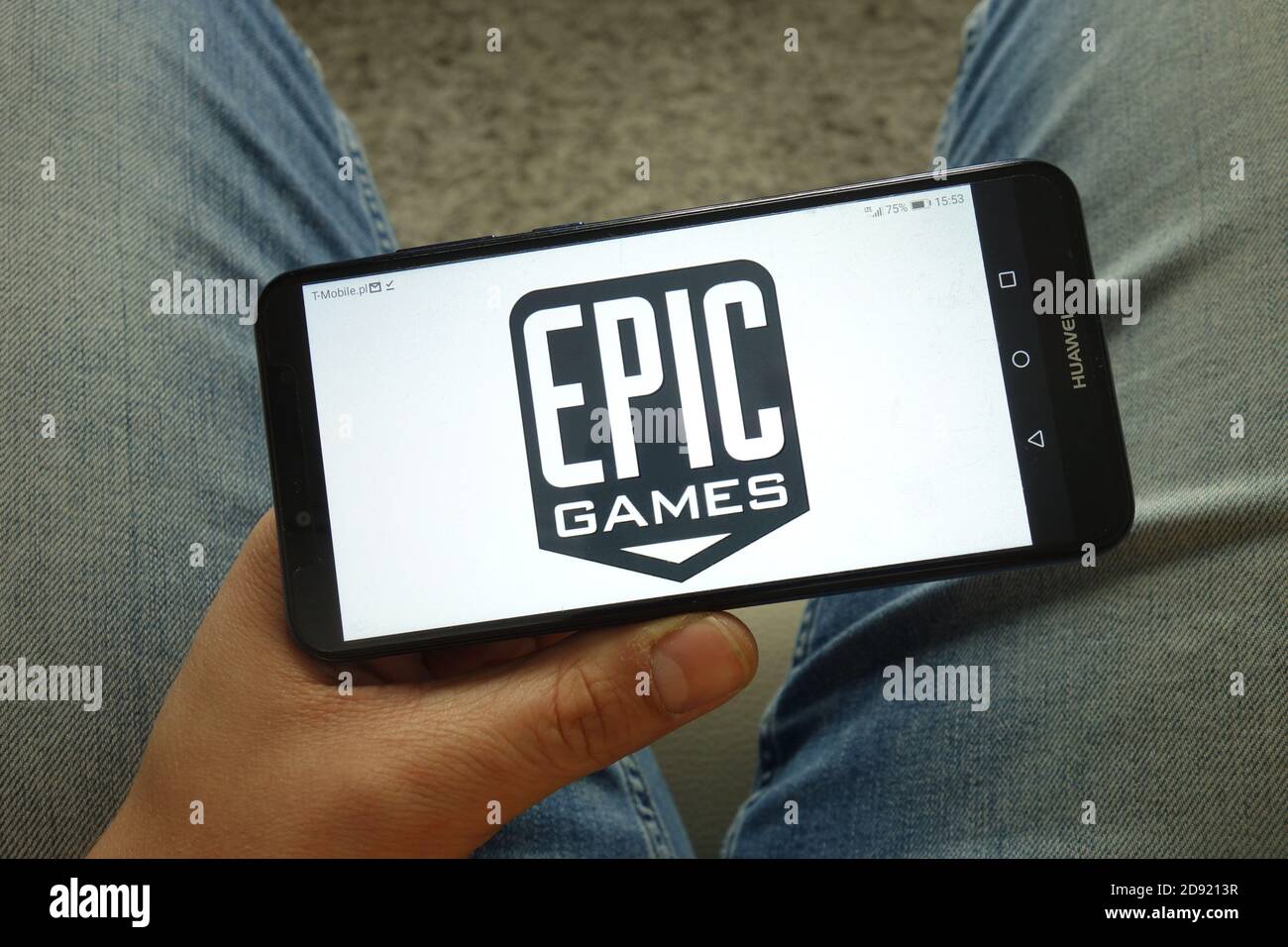 hand holding smartphone with epic games store logo on the screen