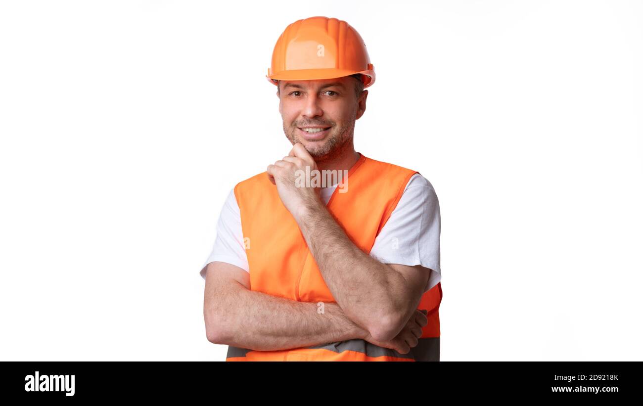 Builder Worker In Orange Uniform Posing Over White Background, Panorama Stock Photo