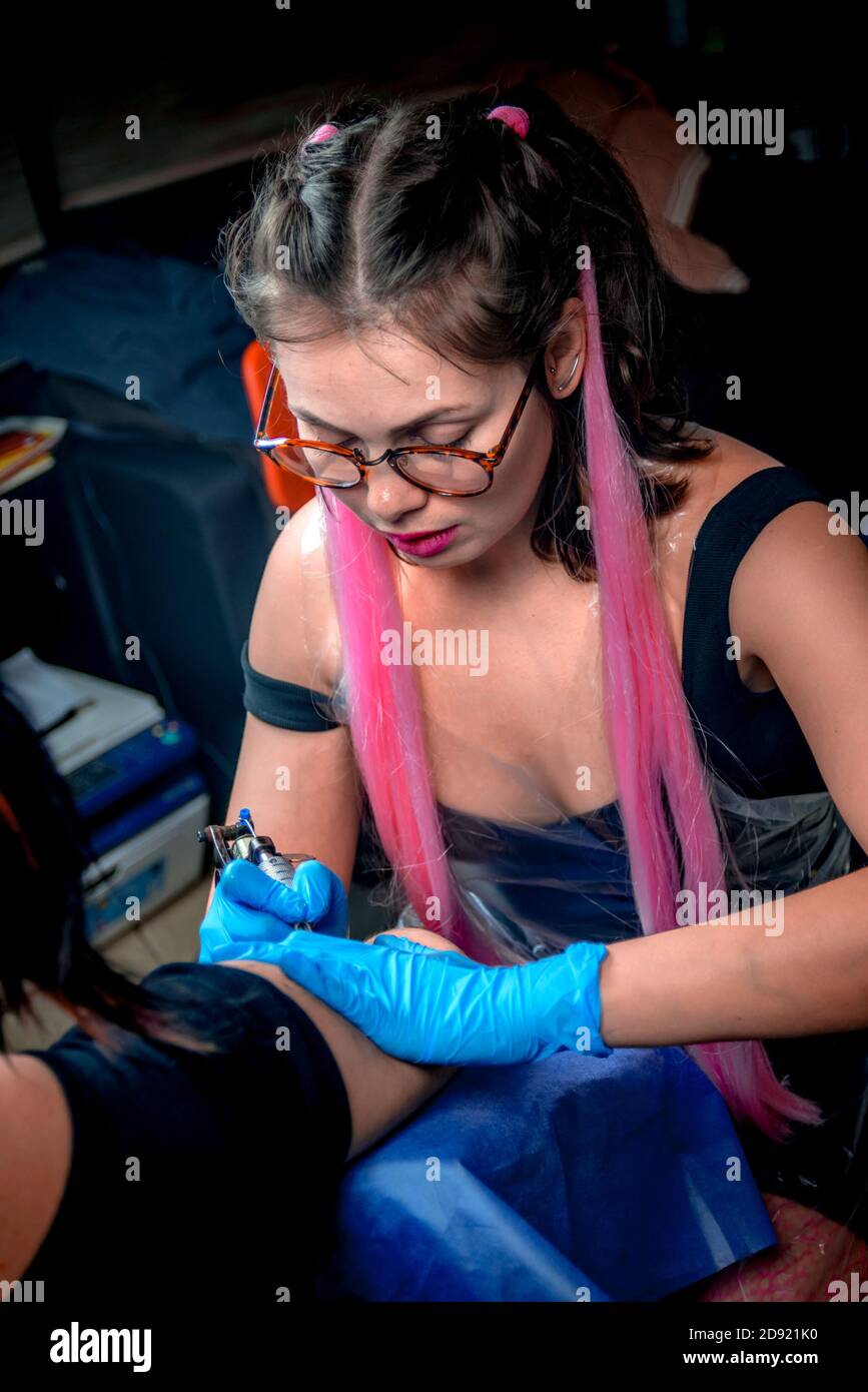 Tattoo specialist makes tattoo pictures in studio Stock Photo