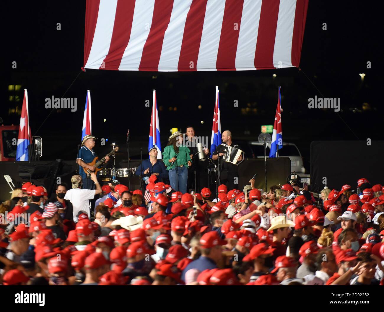Opa Locka, United States. 01st Nov, 2020. November 1, 2020 - Opa-Locka, Florida, United States - The musical group Los 3 De La Habana performs as people wait to hear U.S. President Donald Trump speak at a campaign rally at Miami-Opa Locka Executive Airport on November 1, 2020 in Opa-Locka, Florida. President Trump held events in five states today, as he continues his campaign against Democratic presidential nominee Joe Biden two days before the November 3 election. Credit: Paul Hennessy/Alamy Live News Stock Photo