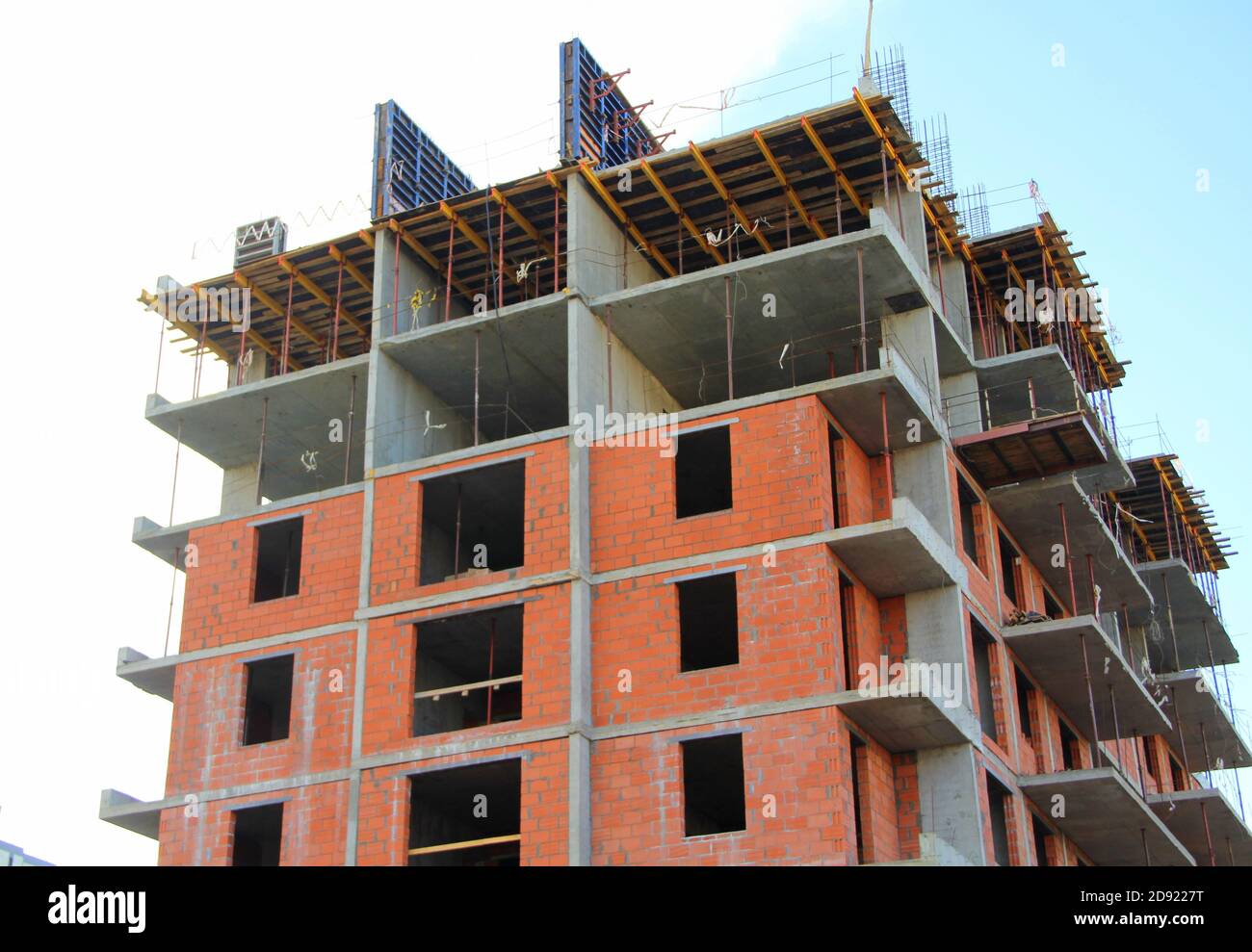 A multistorey apartment building is being built with brick and