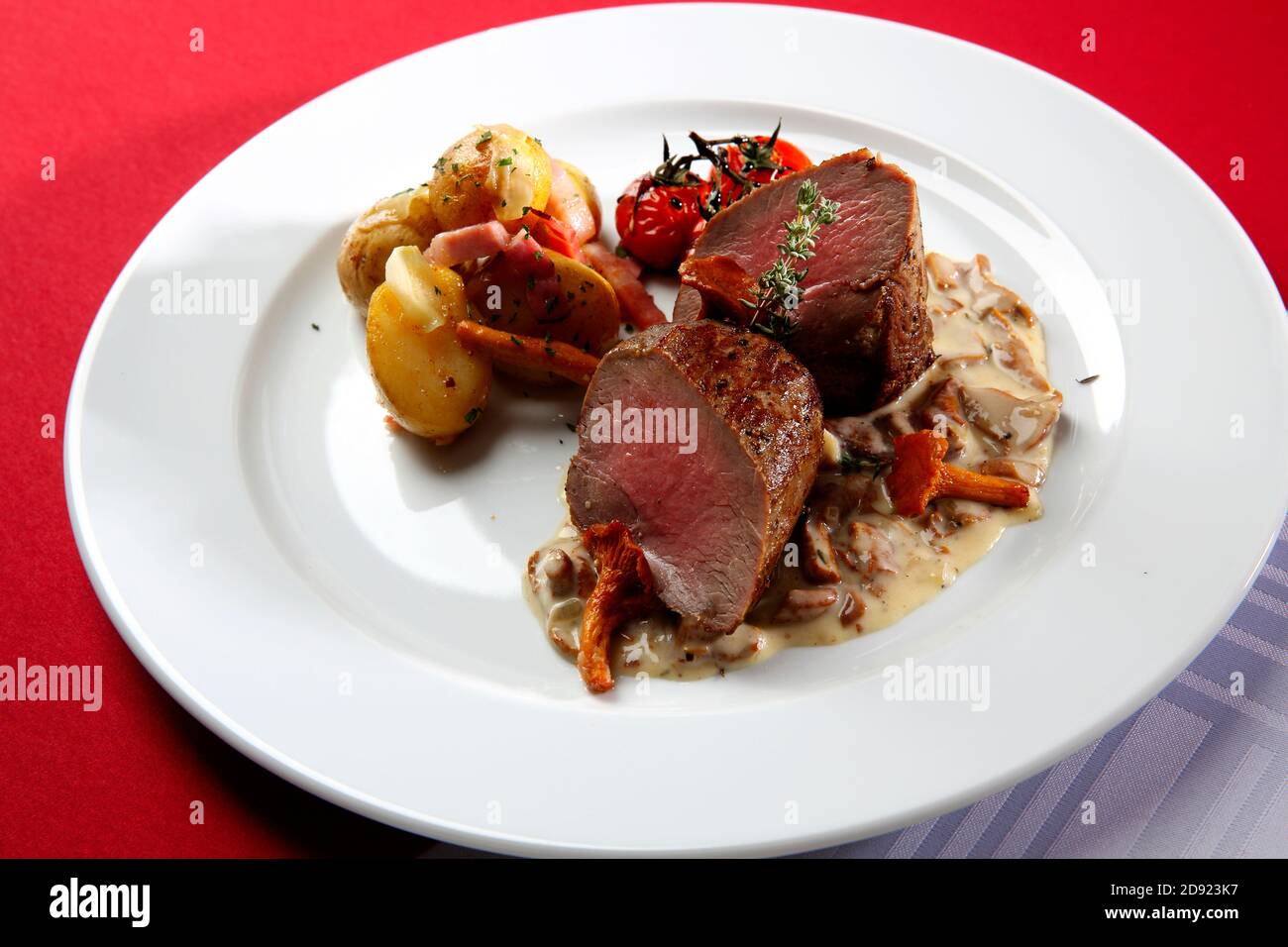 Deer Steak with Creamy Chanterelle Mushrooms Sauce, tomatoes and