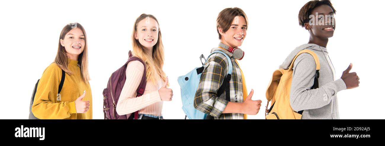 Panoramic shot of smiling multicultural teenagers showing like gesture isolated on white Stock Photo