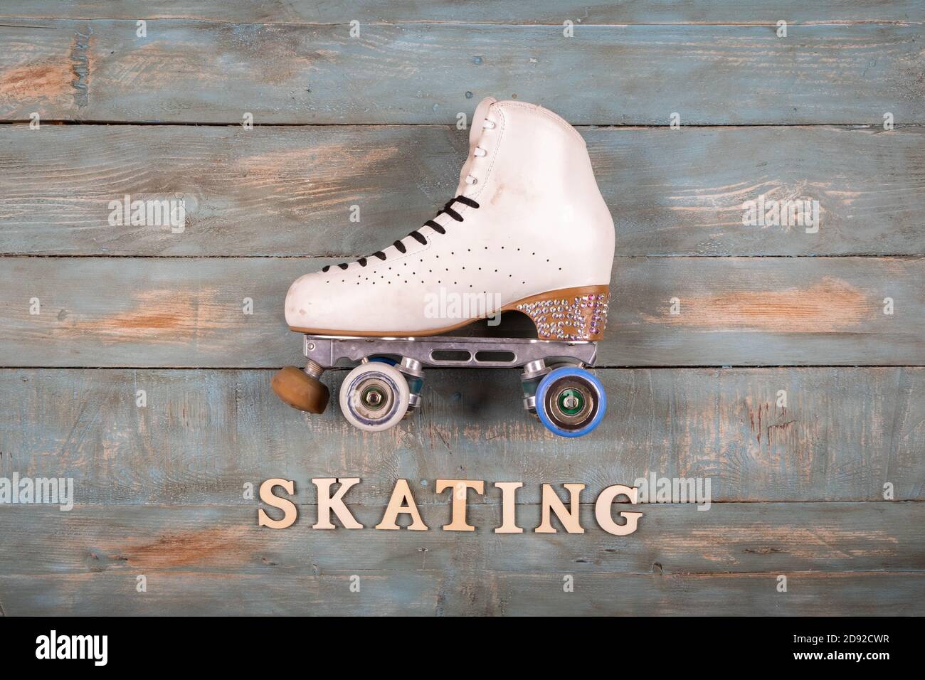 artistic roller skates on a wood background with skating word formed