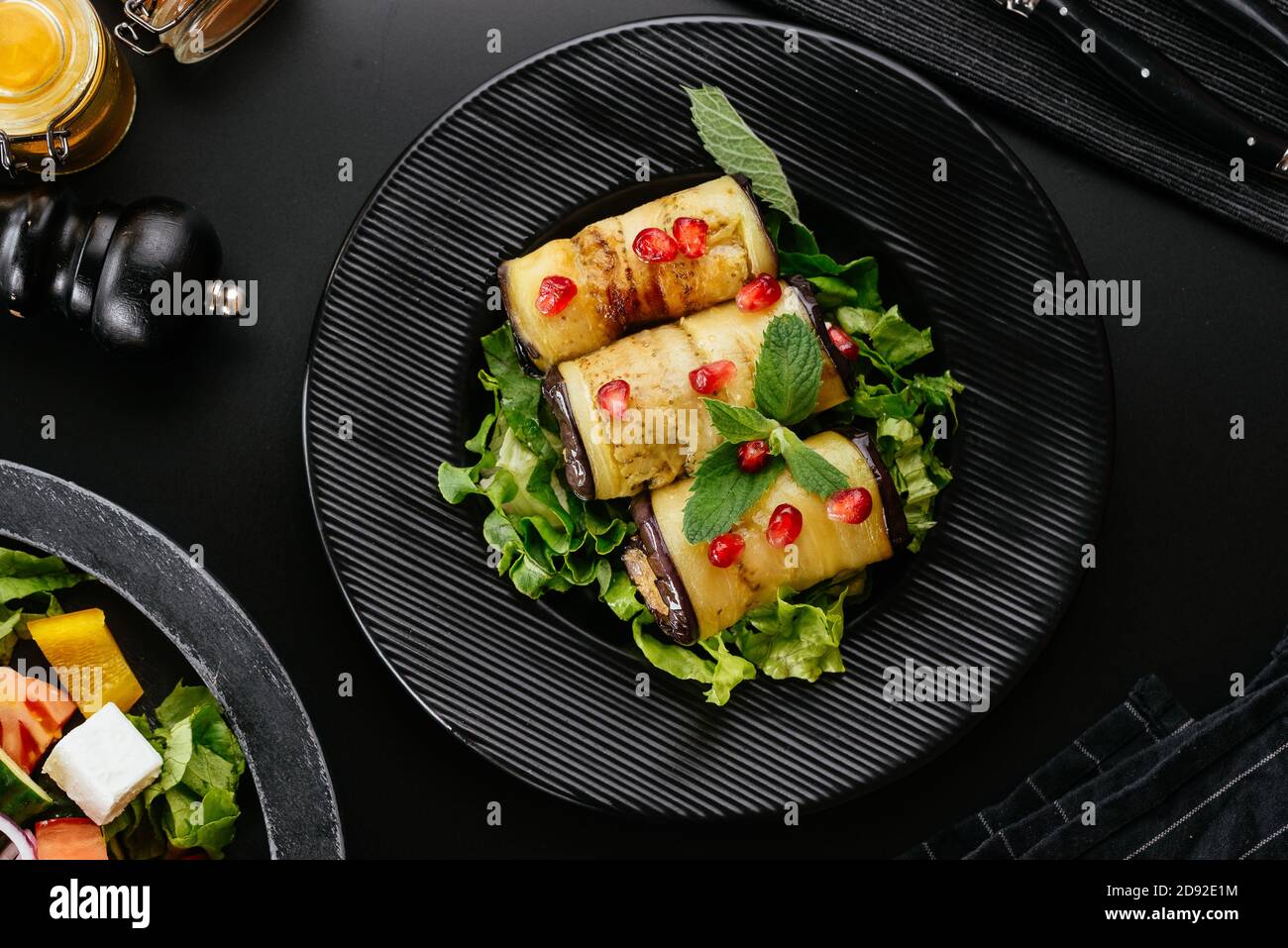 fried eggplant rolls with vegetables on the background Stock Photo