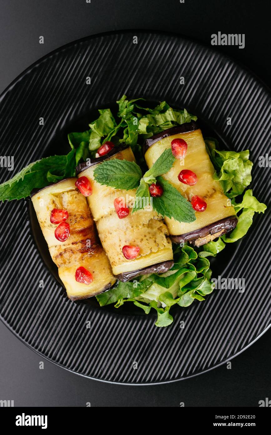 fried eggplant rolls with vegetables on the background Stock Photo