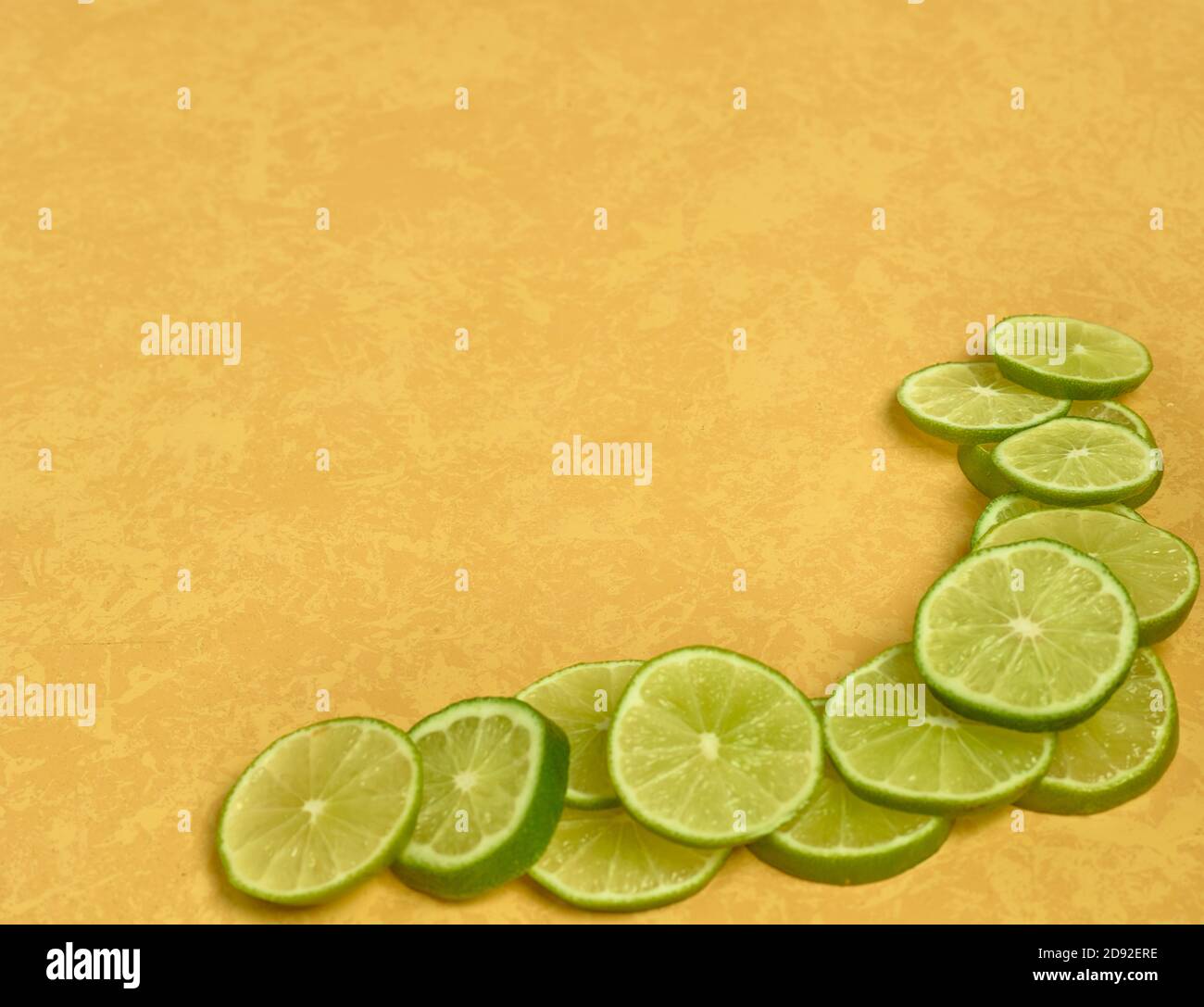 Limes on Yellow Backgropund Stock Photo Alamy