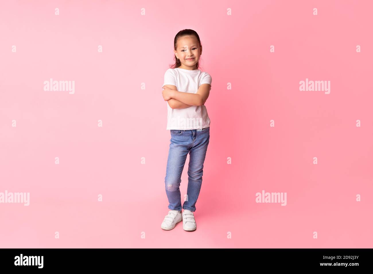 Smiling asian girl posing and looking at camera Stock Photo