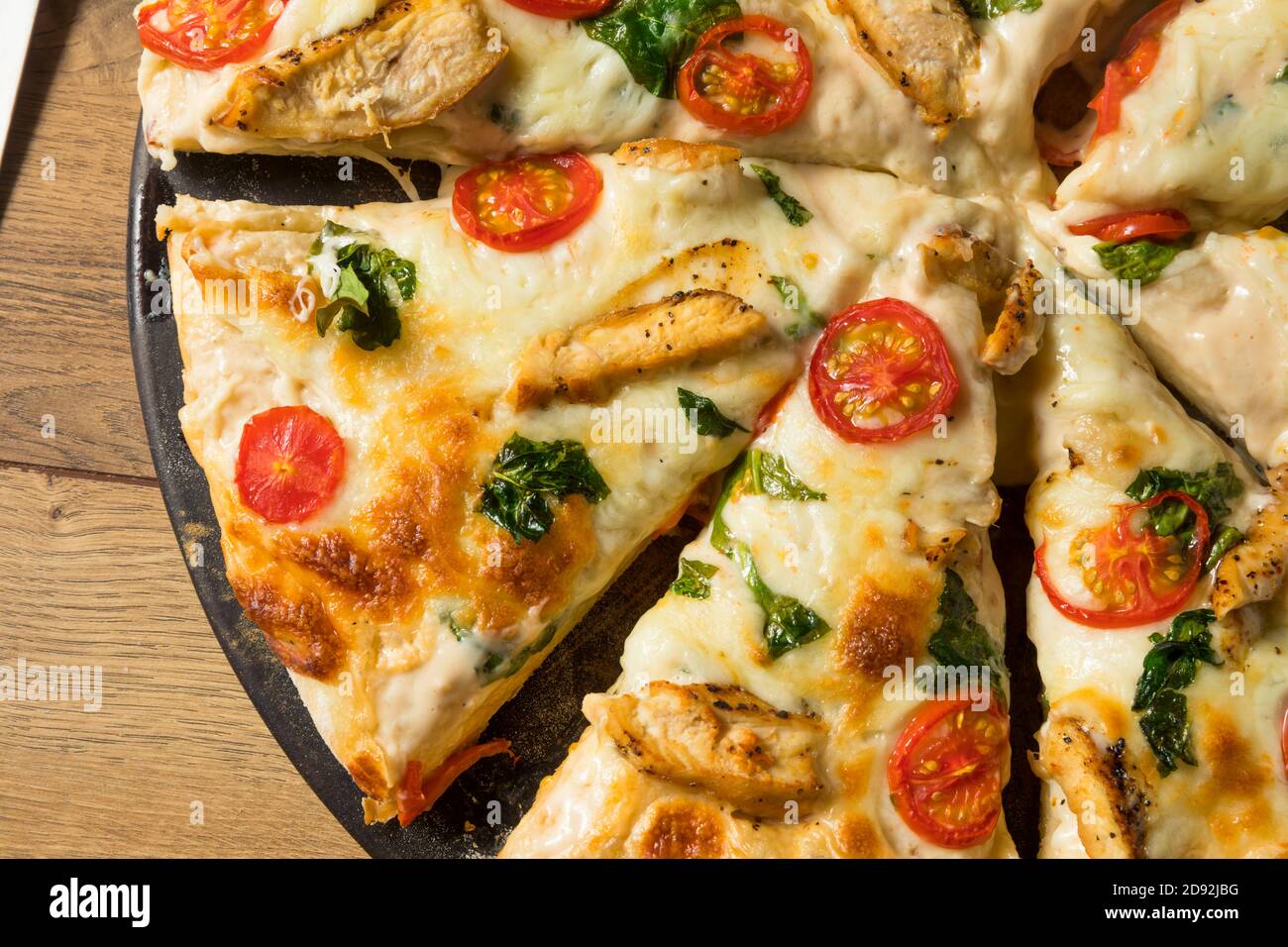 Homemade Chicken Alfredo Pizza with Tomato and Basil Stock Photo Alamy
