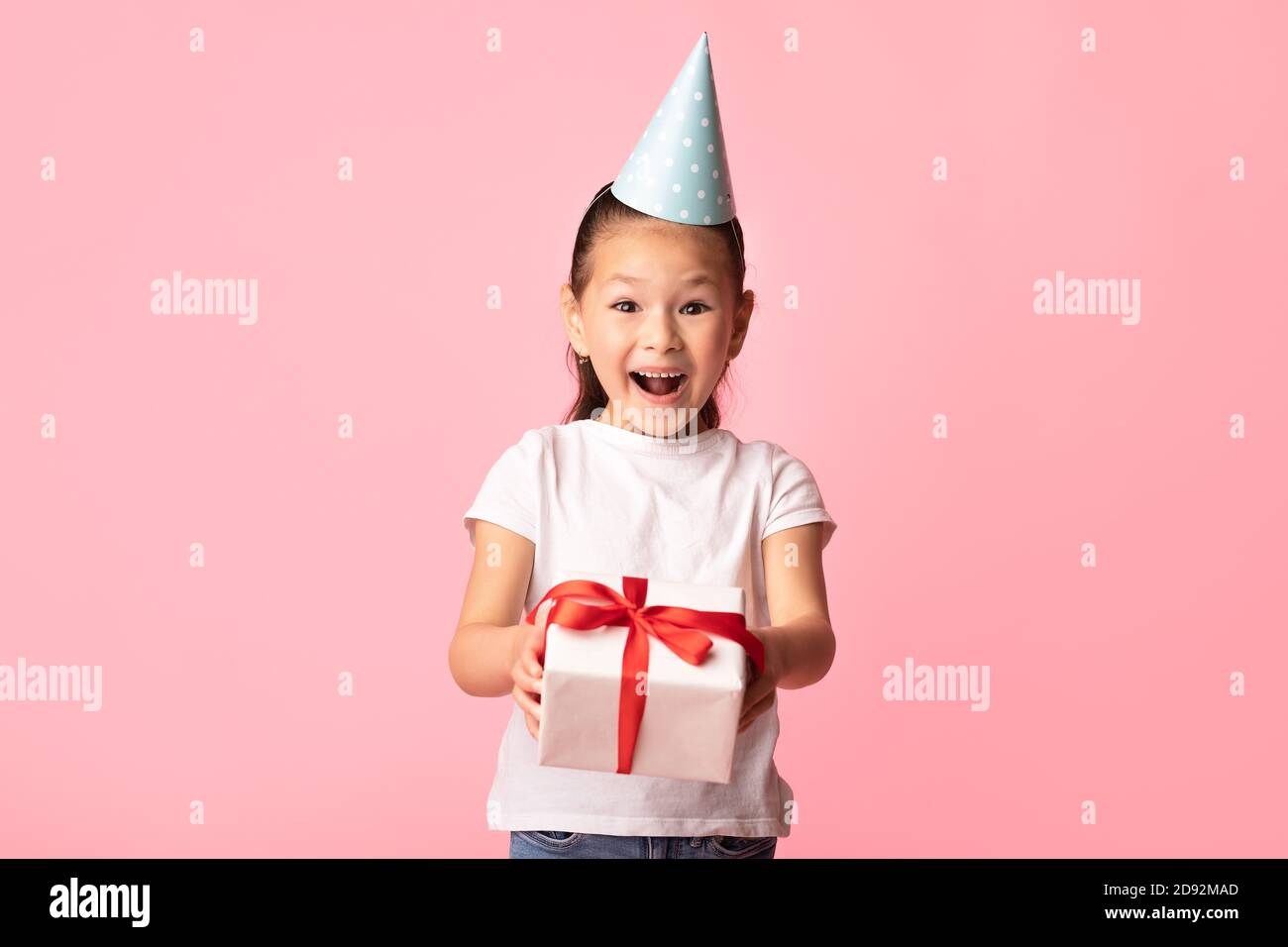 Happy asian girl giving you gift box at yellow studio Stock Photo - Alamy