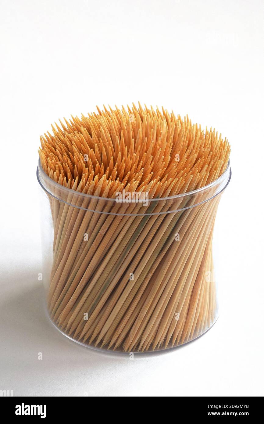 Bamboo toothpicks in a plastic transparent container on white background Stock Photo