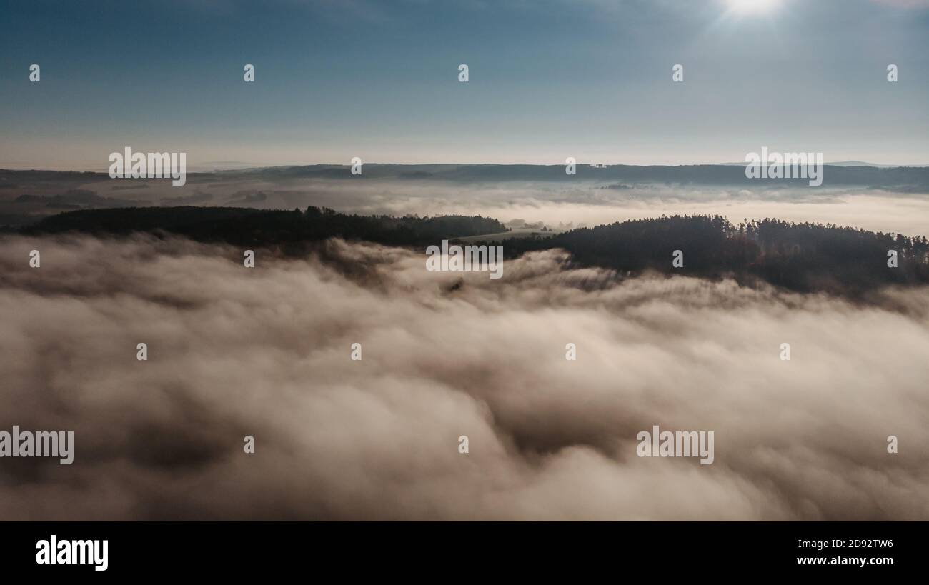 Aerial view of morning foggy landscape. Fall autumn peaceful scenery. Misty calm atmosphere. Drone photo of Czech mountains. Trees in fog. Fairy tale Stock Photo