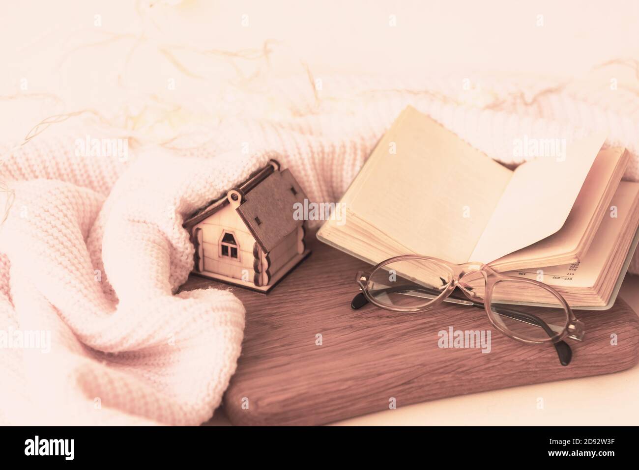 Open book, reading glasses soft blanket home decor Stock Photo