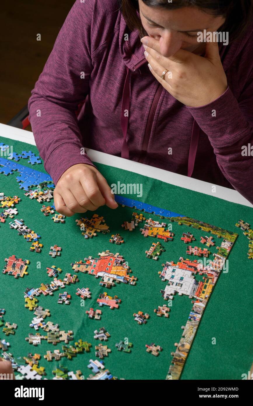 Elevated view of woman arranging  jigsaw  puzzle Stock Photo