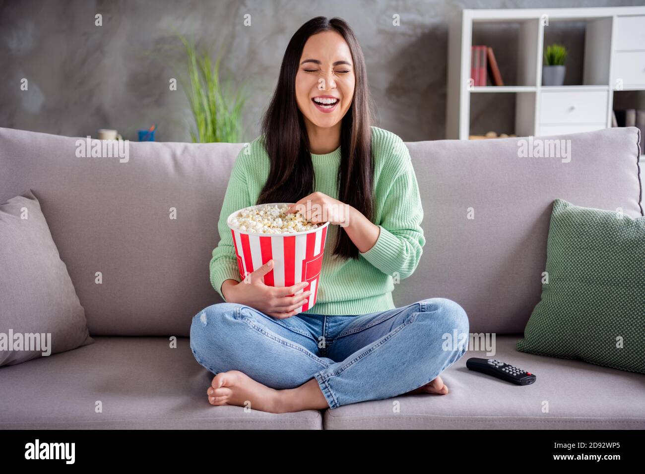 Full body photo of candid pretty korean girl sit divan legs bare foot 