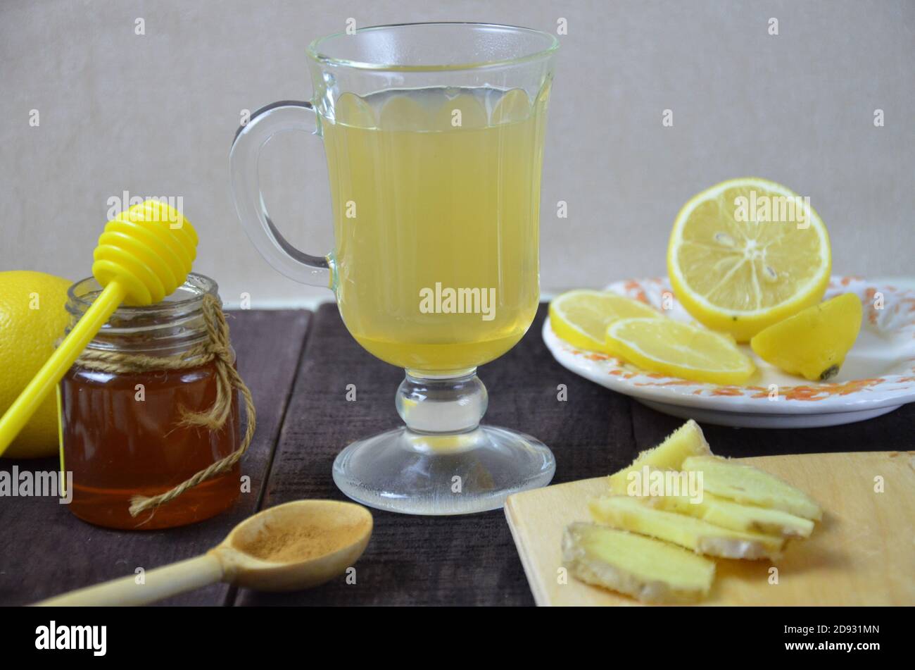 Hot drink with honey, lemon and ginger for cough remedy on wooden table
