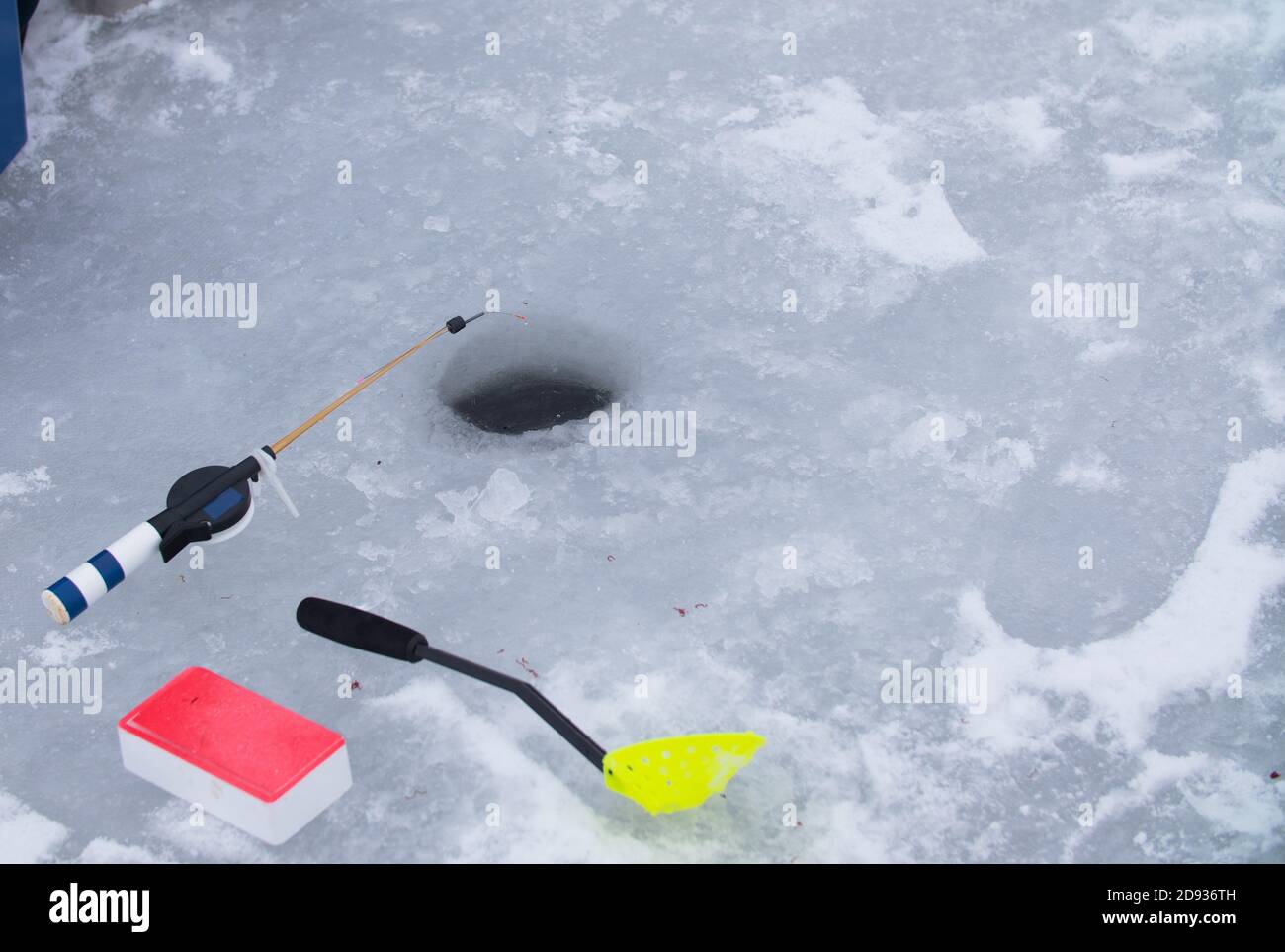 Winter fishing. Fishing rod stands on the ice. Fishing theme Stock