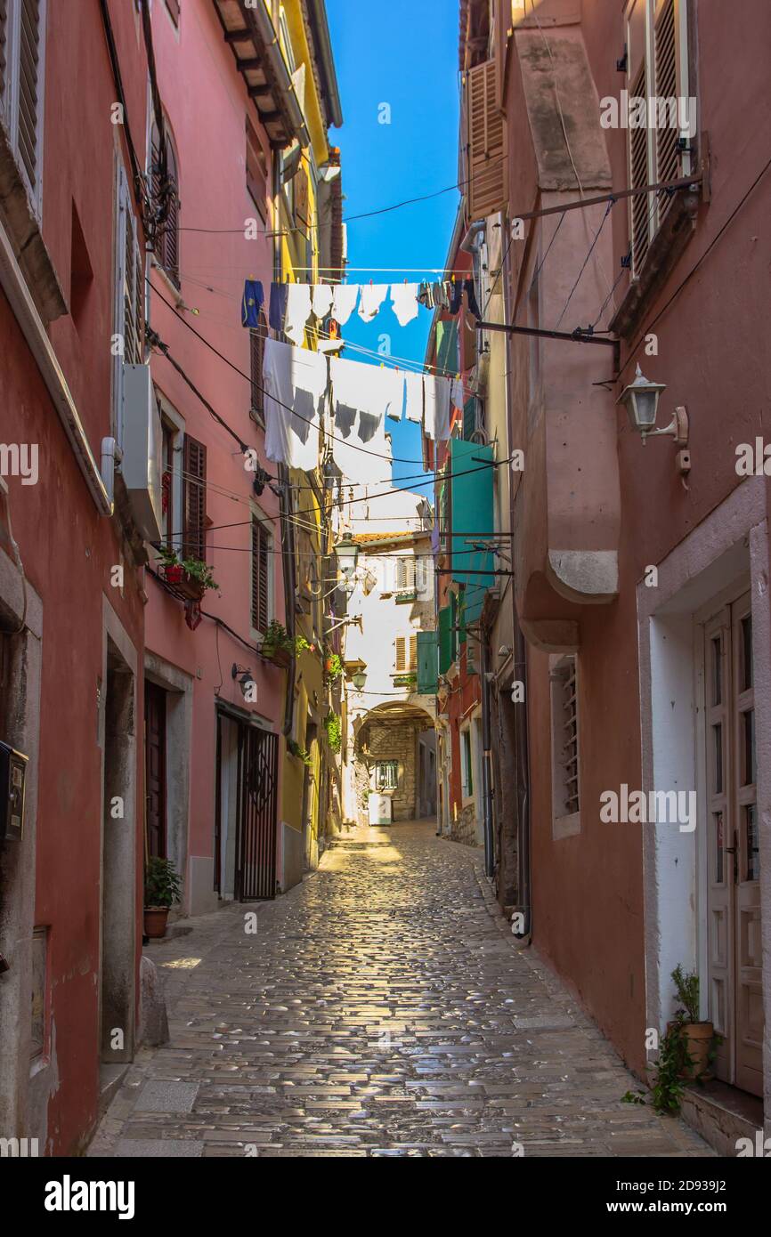 Morning walk in empty Croatian city of Rovinj.Picturesque narrow cobblestone streets,colorful facades,small shops,beautiful European cityscape.Summer Stock Photo