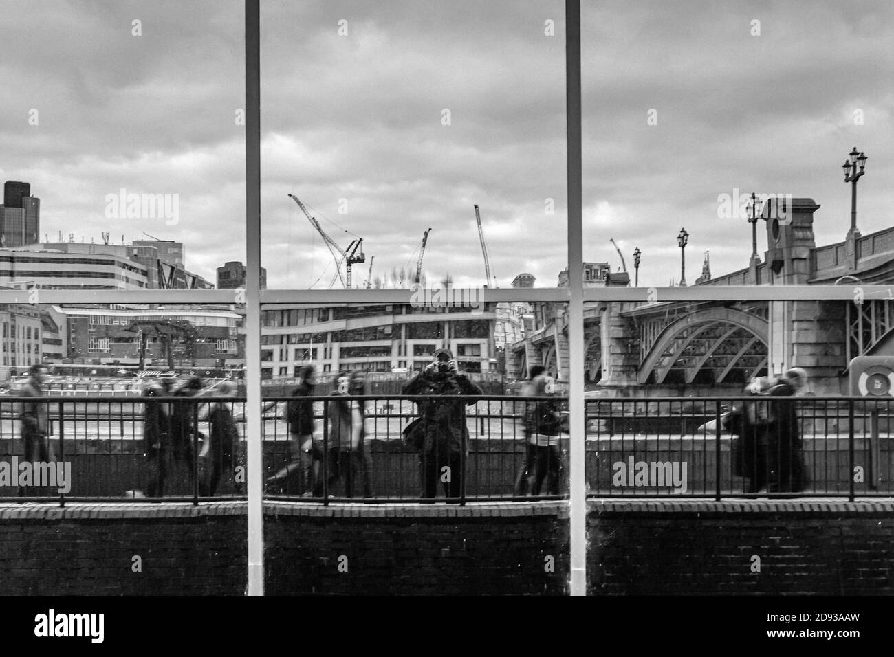 London, UK, December 7, 2013: passersby are reflected in a window at Southwark Bridge Road Stock Photo