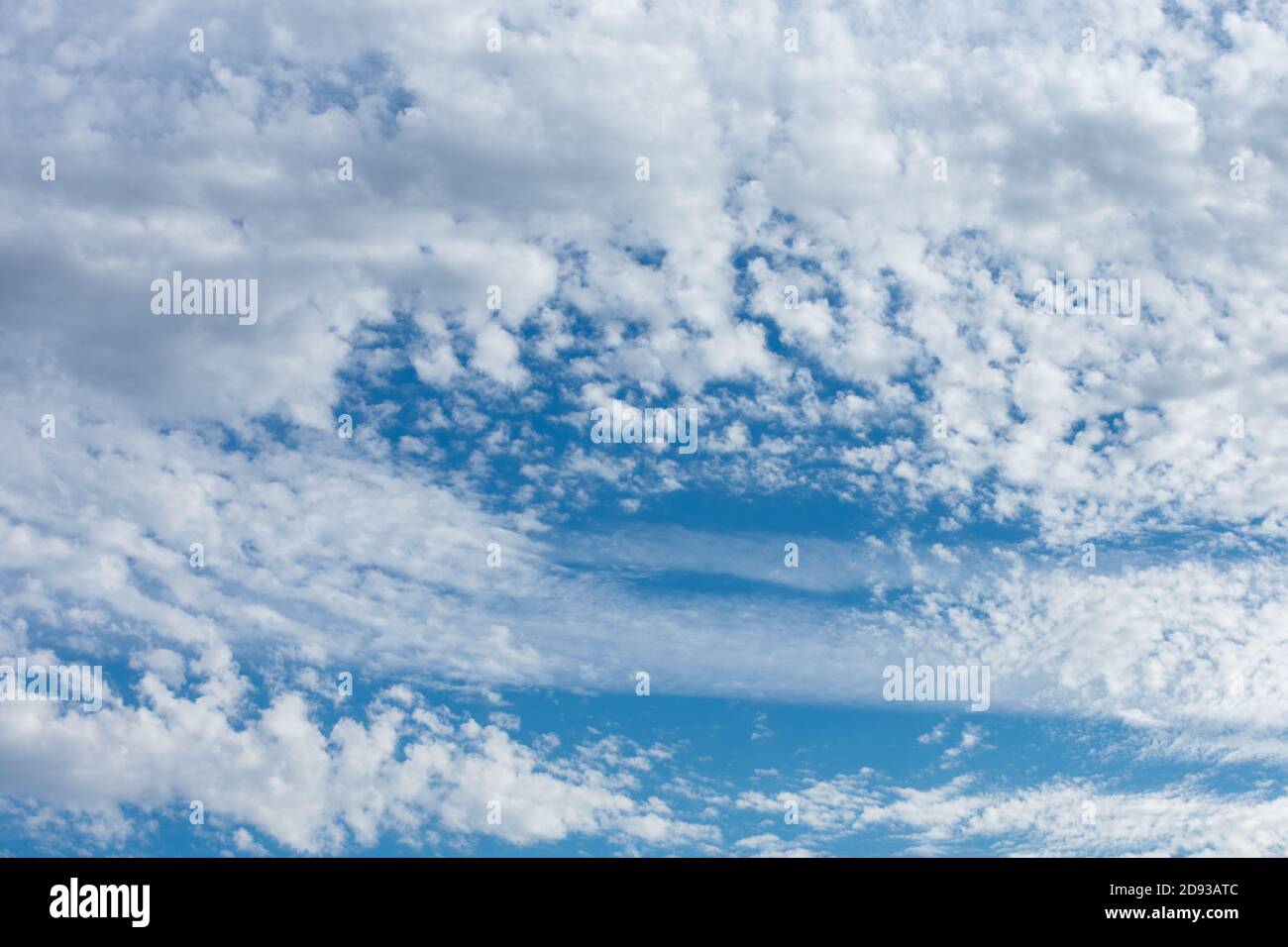 A Light Blue Sky With Whispy and Fluffy Clouds for Sky Replacement Stock Photo
