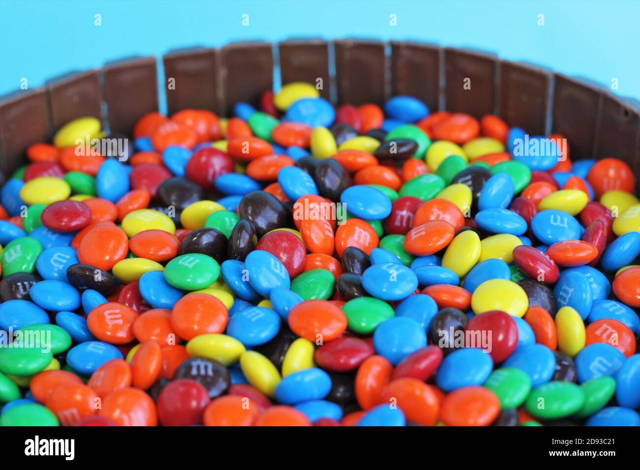 M and M's candy enclosed by a ring of Kit Kat candy bars. Stock Photo