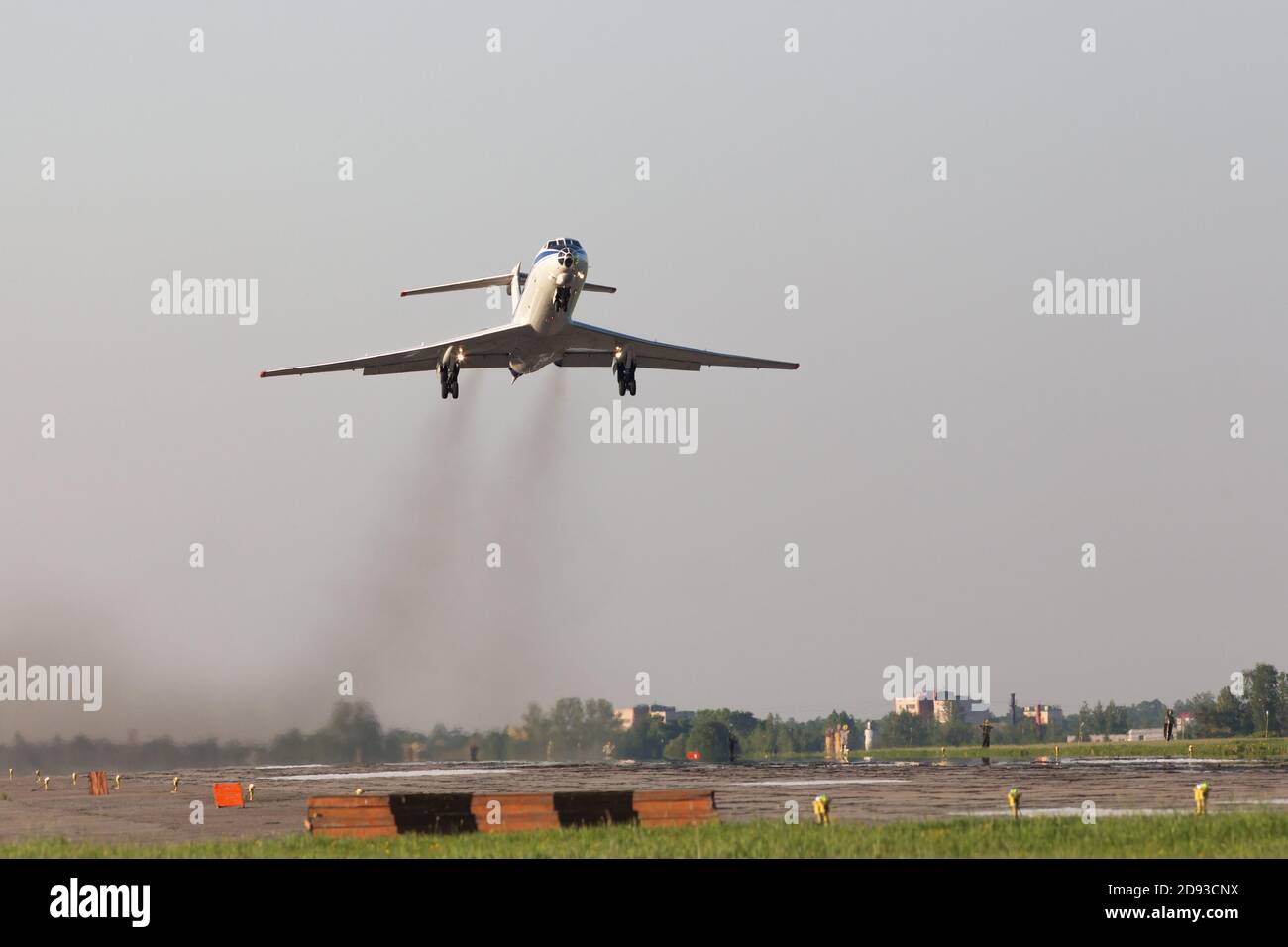 Airplane take off from military airfield. Smoke from engines, low over the runway. Transportation, aviation. Stock Photo