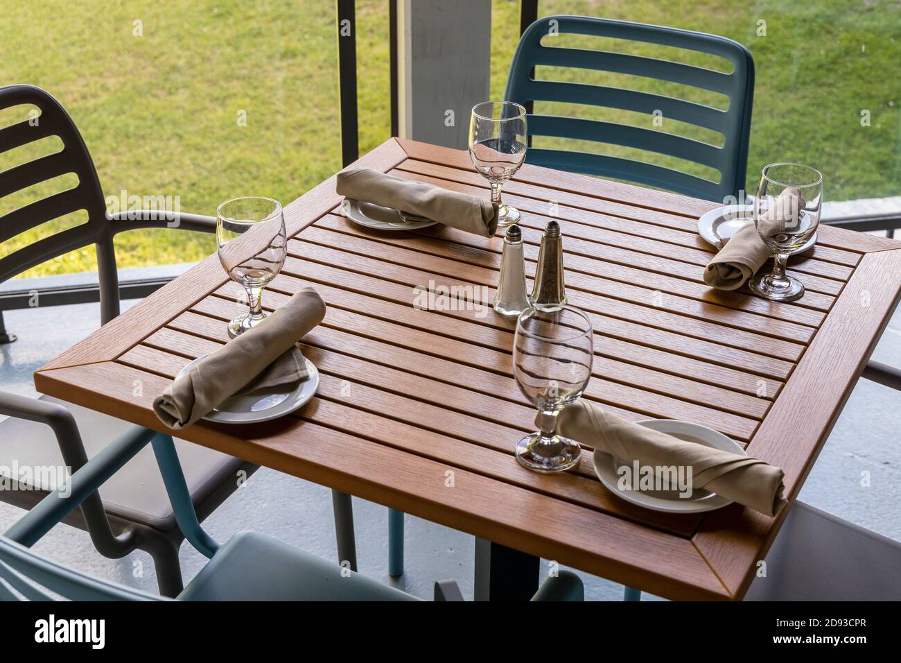 A causal dining table setting on a patio for lunch or dinner Stock