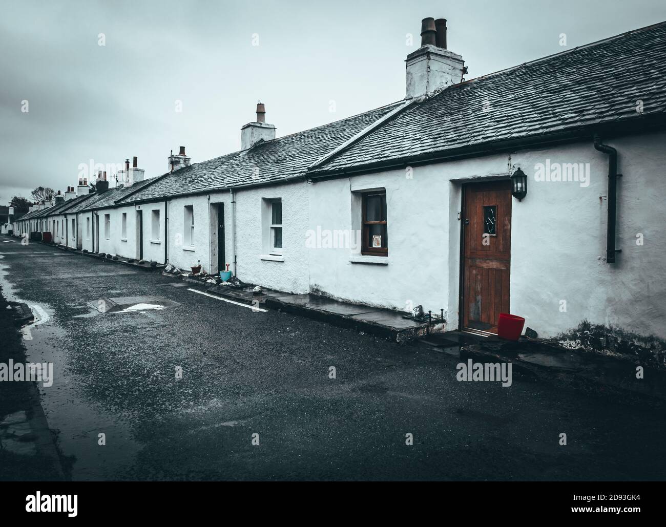 Black and white photo of a street of white single storey cottages, Ellenabeich, Easdale, Isle of Seil, Scotland Stock Photo