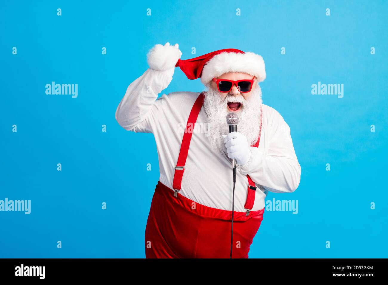 Photo of hipster funky pop star celebrity santa claus with beard big  abdomen sing song microphone wear style stylish suspenders overalls  headwear Stock Photo - Alamy