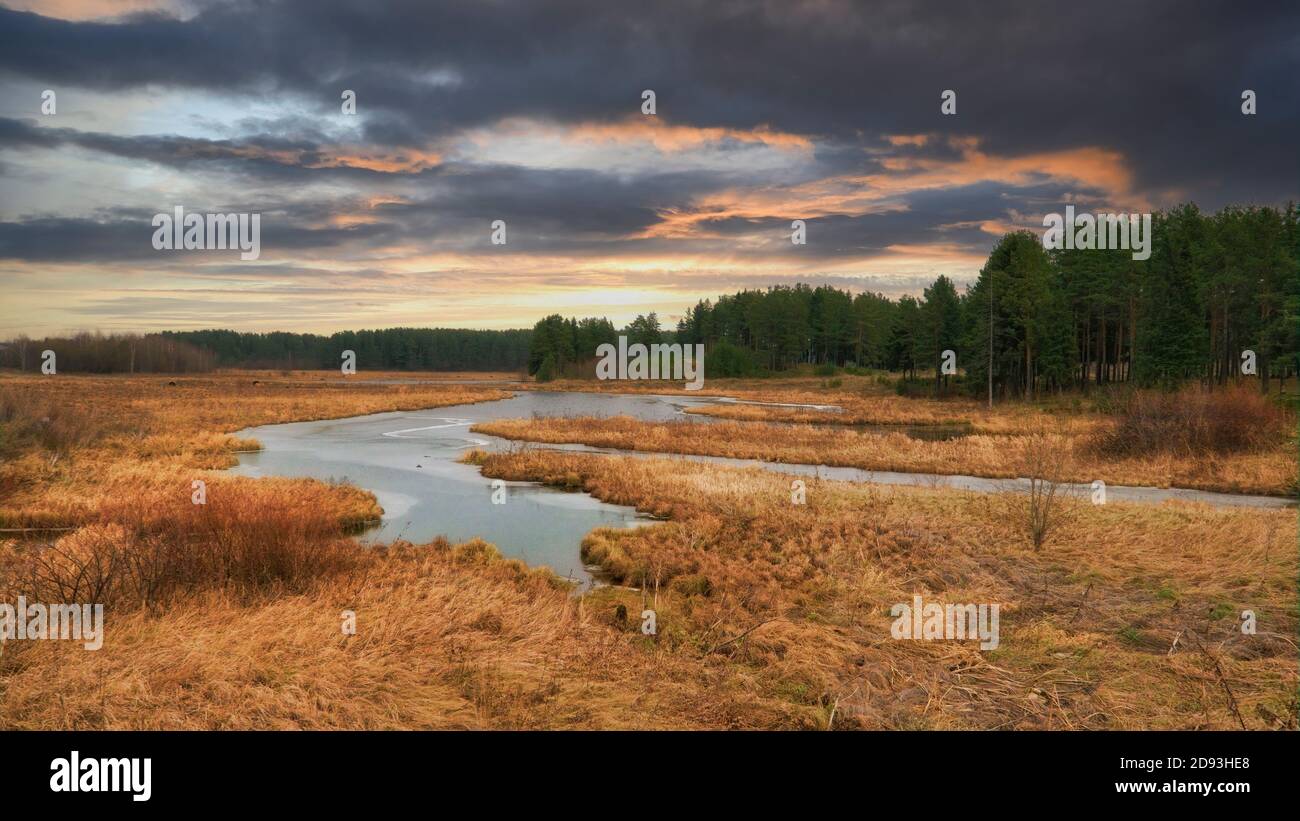 Picturesque autumn landscape with riverbank at sunset. Wonderful nature, beautiful natural background. Stock Photo