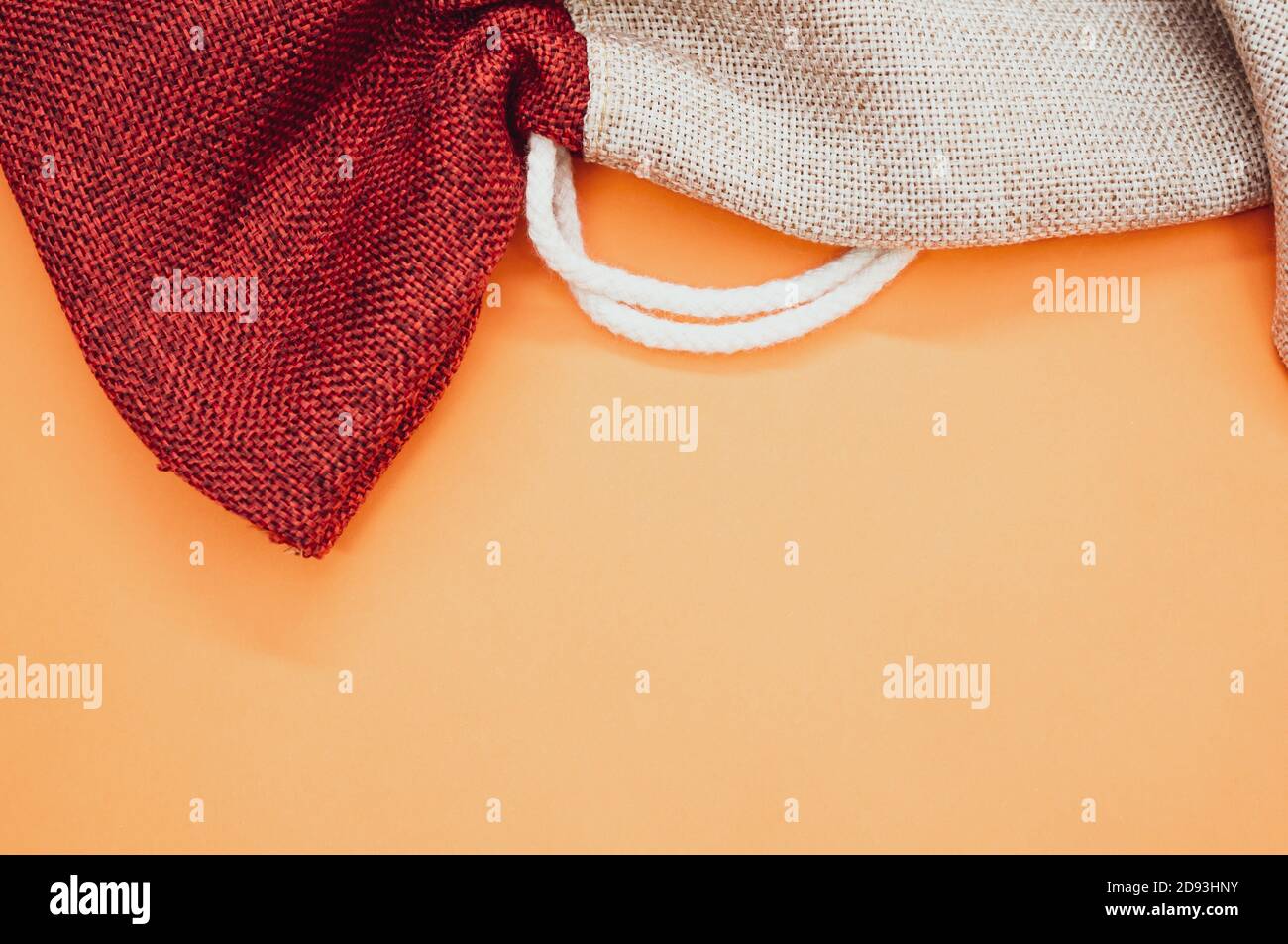decorative rough textile sacks on an orange background Stock Photo