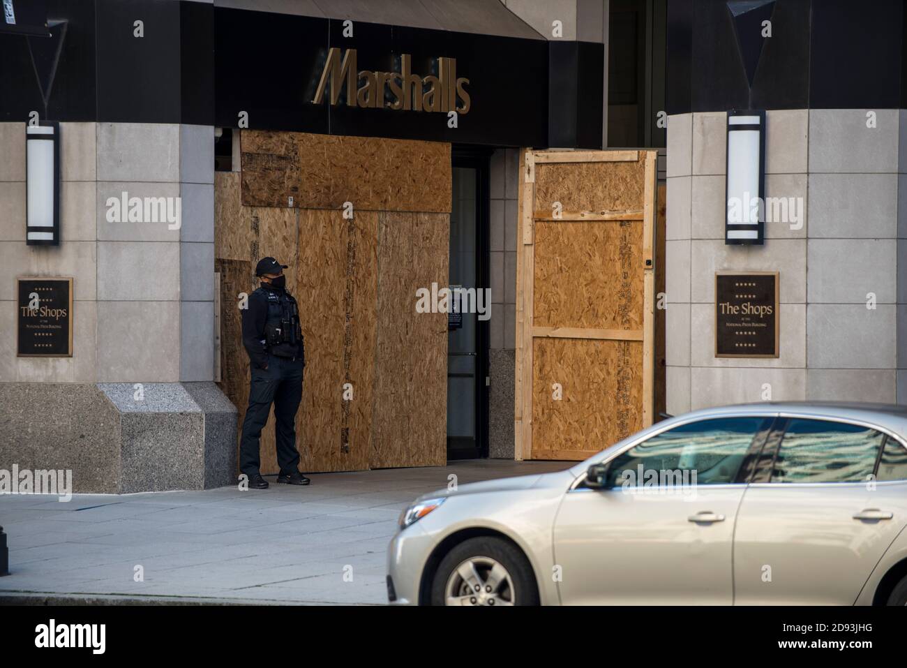 Washington, USA. 2nd Nov, 2020. Security officer in front of Boarded up entrance to Marshalls store in preparation for possible election related riots in Washington, DC, USA. Credit: Yuriy Zahvoyskyy/ Alamy Live News Stock Photo
