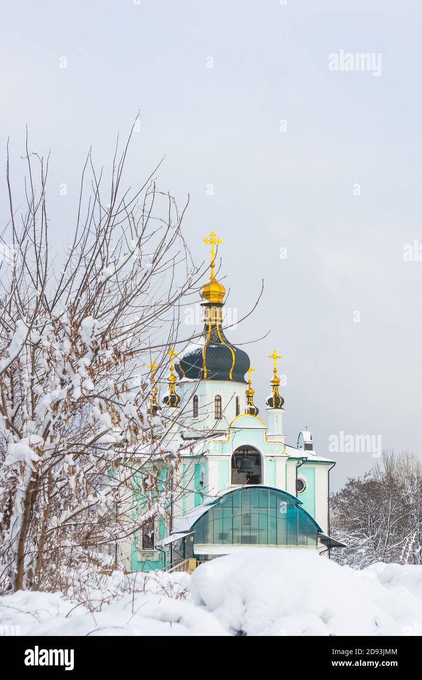 Winter landscape - Orthodox church in the snow among trees on a cold frosty day Stock Photo