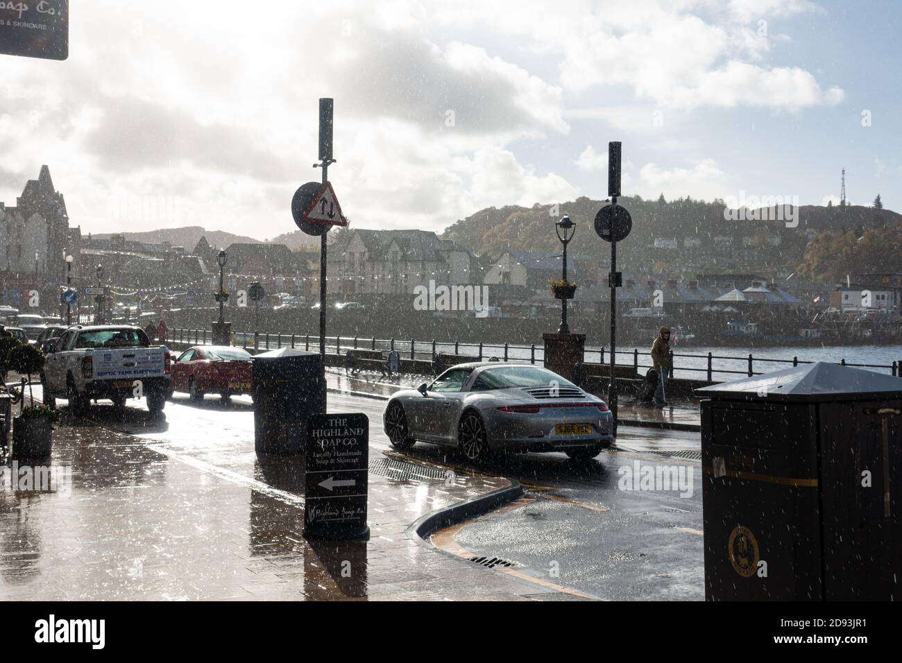 Oban high street during a heavy autumn shower while still sunny Stock Photo