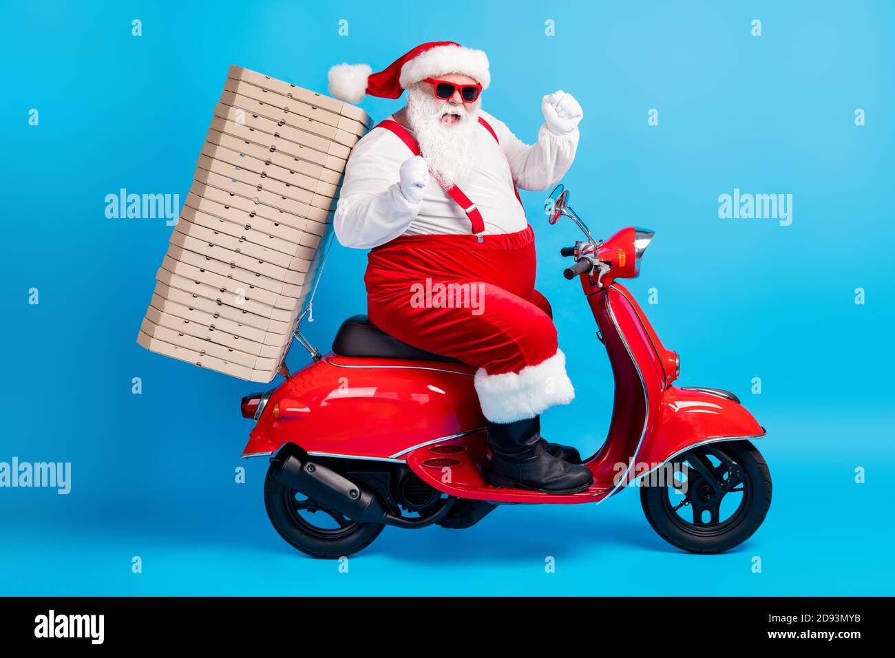 X-mas christmas tradition win full length profile side photo of white grey  bearded hair santa claus drive scooter deliver pizza raise fists wear red  Stock Photo - Alamy