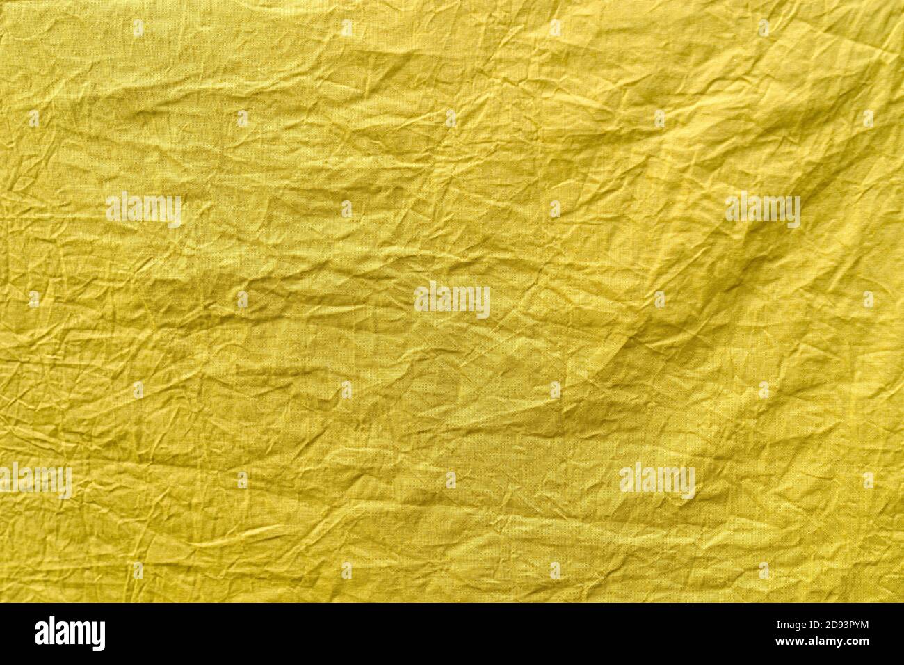 Light yellow crumpled cotton thin fabric dyed with natural vegetable dyes. Without picture. Abstraction, background, texture, copy space Stock Photo
