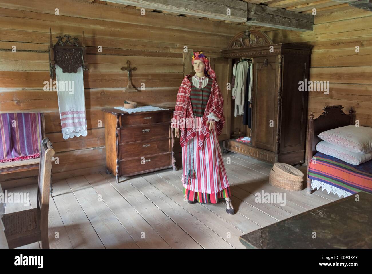 Model of a woman and furnishing inside a house at open-air ethnographic museum in Rumsiskes, Lithuania Stock Photo