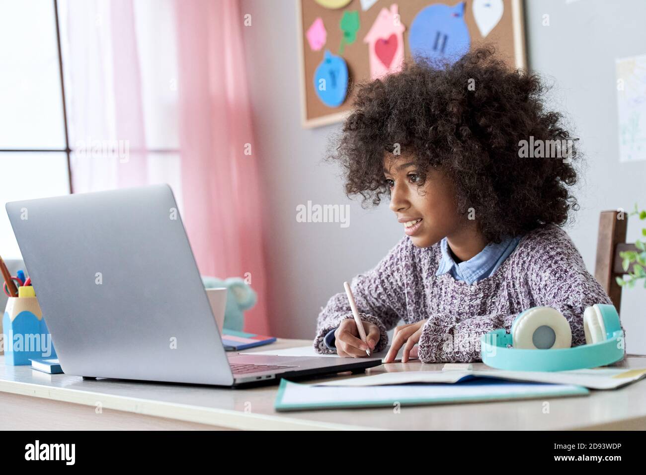 African school child girl elearning online watching video class at home. Stock Photo