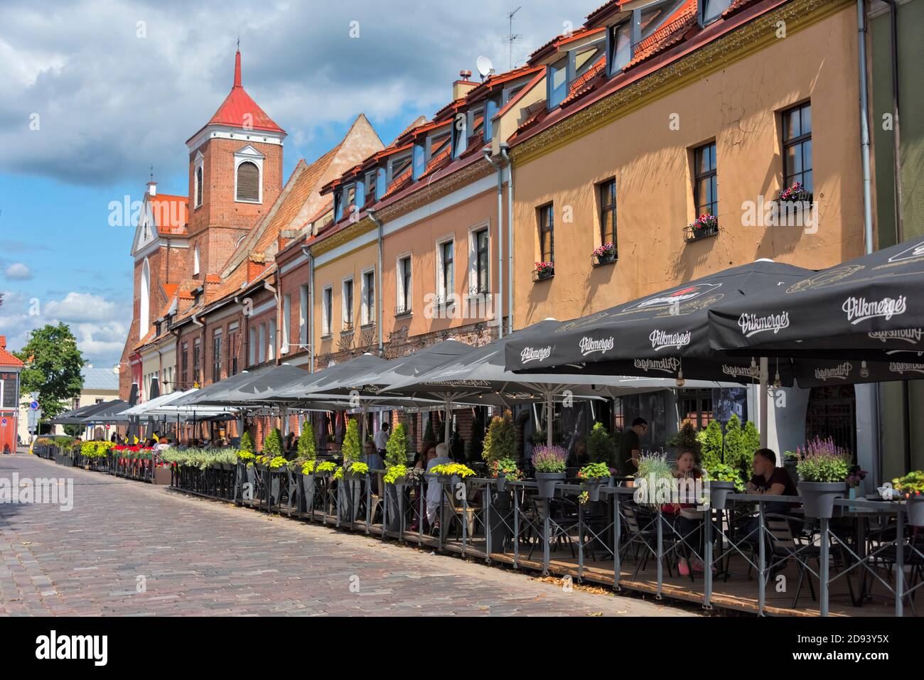 Outdoor cafeteria and Cathedral Basilica of St. Peter and St. Paul, Kaunas, Lithuania Stock Photo